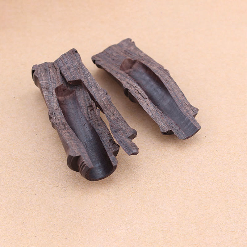 Ebony Wood Bamboo Prayer Box Necklace – Two rustic dark wood troughs with natural bark texture on beige background, workshop material shot