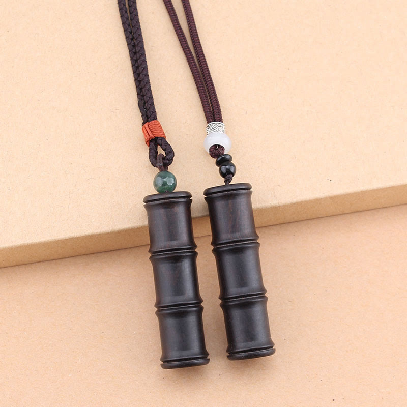 Ebony Wood Bamboo Prayer Box Necklace – Two dark brown bamboo pendant necklaces with decorative bead accents on beige background, side by side comparison