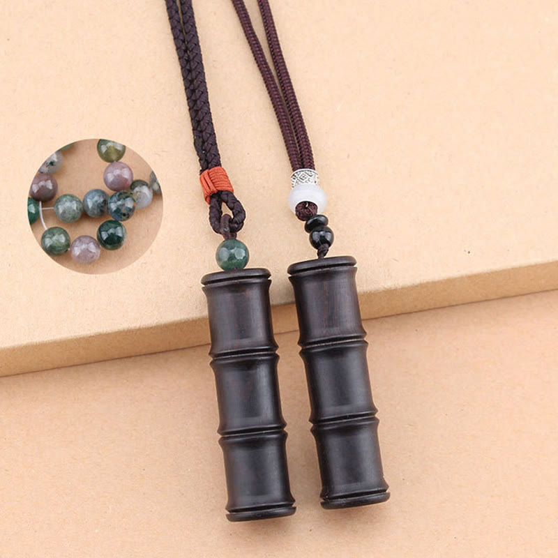 Ebony Wood Bamboo Prayer Box Necklace – Two dark bamboo pendant necklaces with green and white accent beads on dark braided cords, beige background pair shot