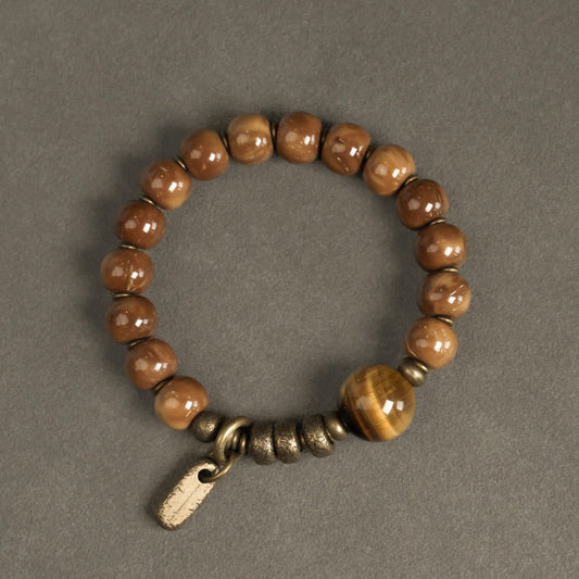 Tiger Eye Obsidian Wealth Bracelet – Glossy brown beads with golden tiger's eye accent and antique brass tag charm, overhead flat lay