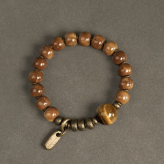 Tiger Eye Obsidian Wealth Bracelet – Glossy brown beads with golden tiger's eye accent and antique brass tag charm, overhead flat lay