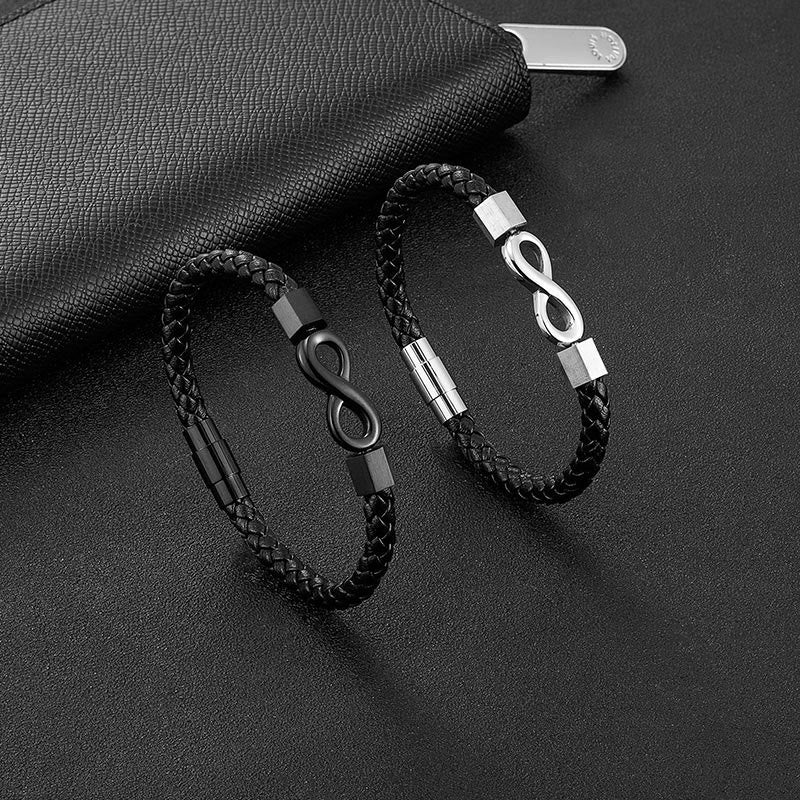Endless Knot Titanium Steel Leather Bracelet – Two leather bracelets with black and silver infinity clasps on textured black leather with zip pouch, elevated angle