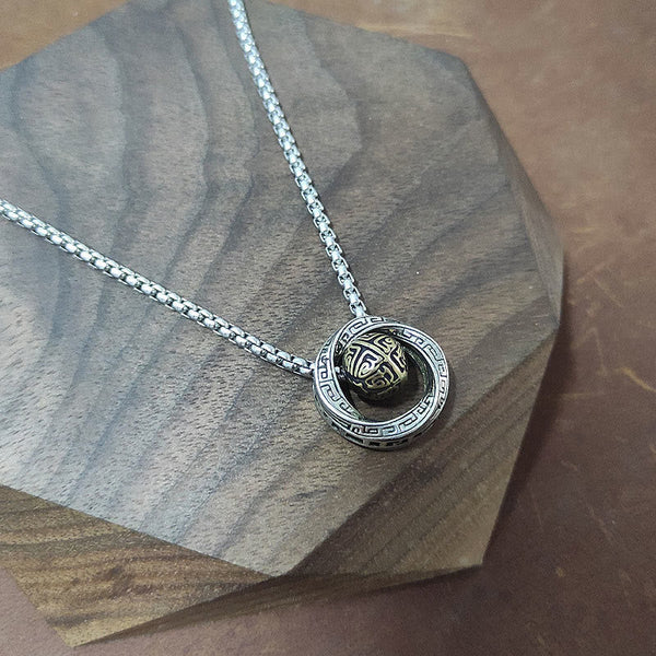 Mobius pendant necklace with loop pendant resting on a dark wood display