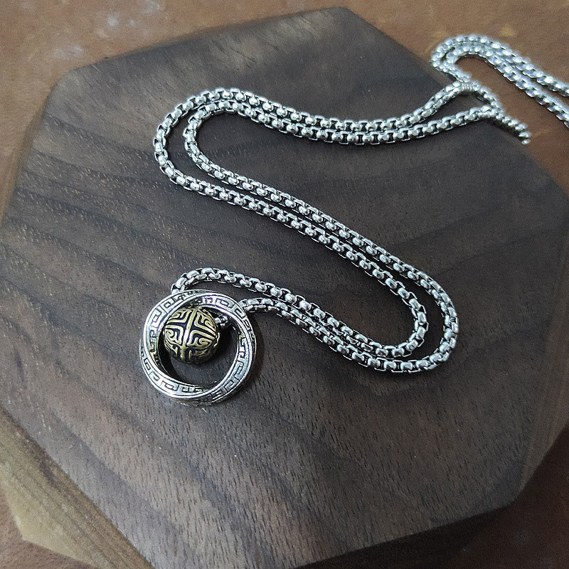Mobius Copper Wealth Necklace – Full silver box chain with Mobius ring pendant laid on dark wood slab, overhead flat lay view