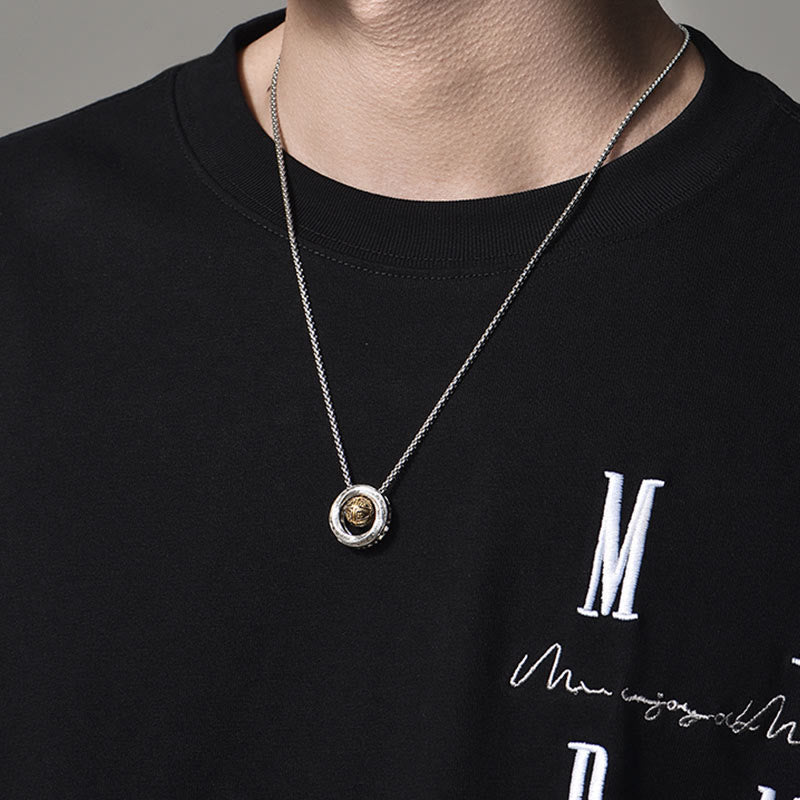 Mobius Copper Wealth Necklace – Silver Mobius pendant with gold center worn on male model in black sweatshirt, chest-level lifestyle shot