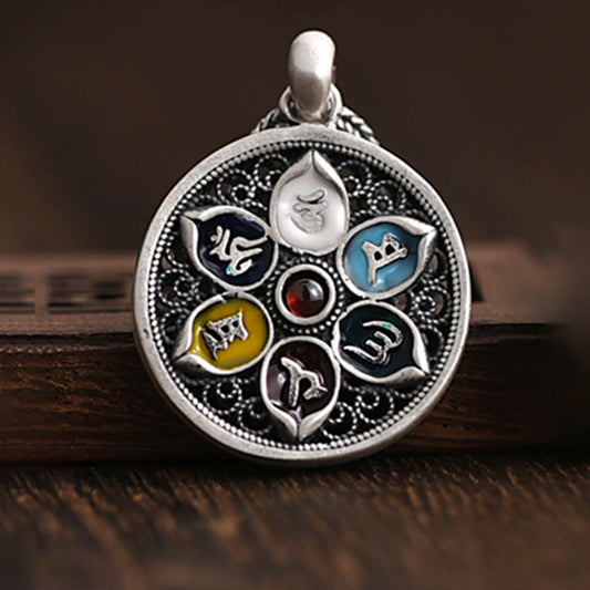 Om Mani Padme Hum Silver Purity Necklace – Silver lotus mandala pendant with multicolored enamel petals containing Tibetan script and red center, warm brown wood