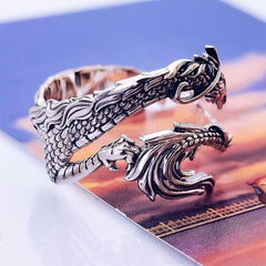 Vintage Dragon Pattern Silver Ring – Silver dragon ring detail shot showing scale texture and design elements on warm surface, close-up angle