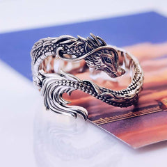 Vintage Dragon Pattern Silver Ring – Silver dragon ring with intricate scales and fierce serpentine head, blue orange printed background, three-quarter side angle