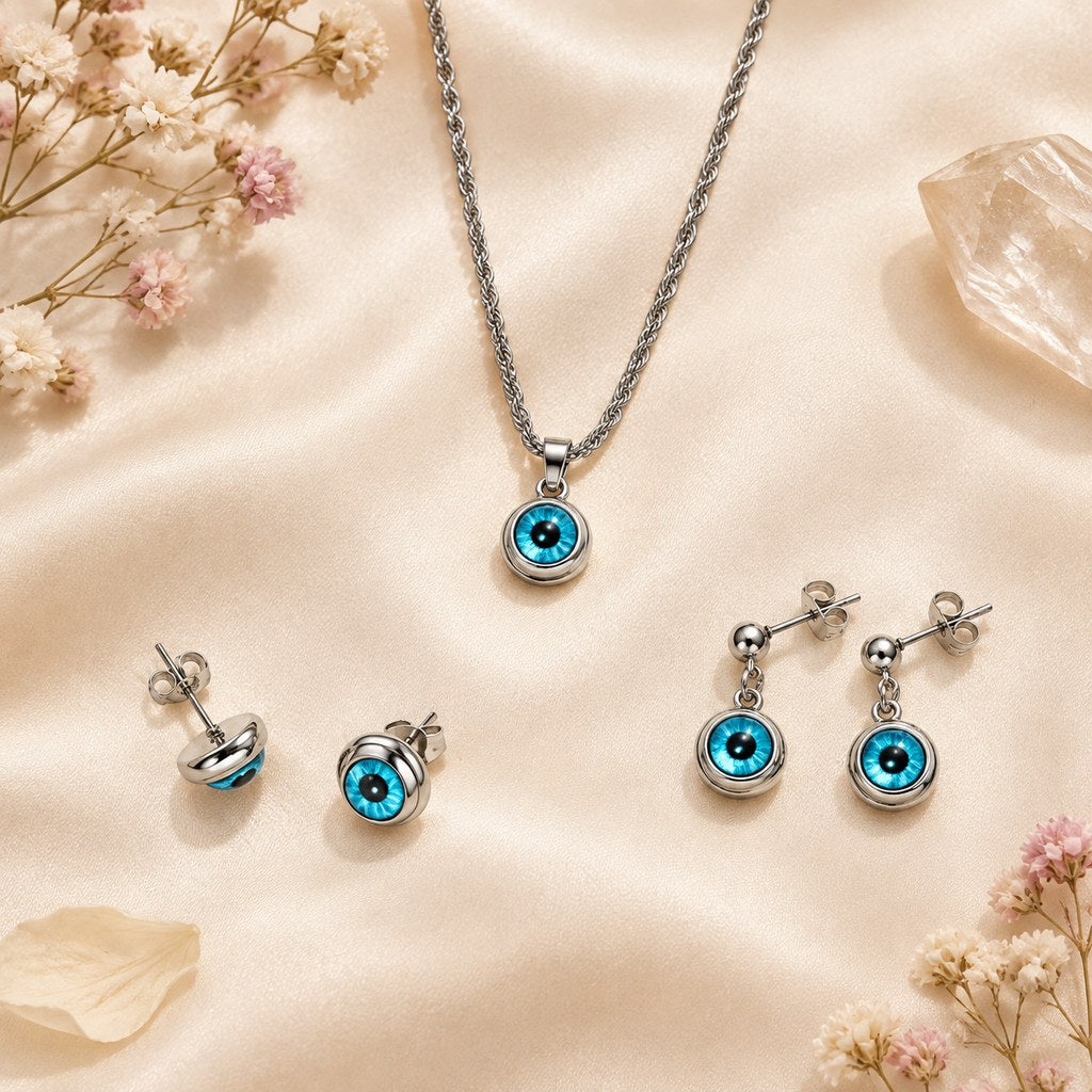 Silver Blue Evil Eye Jewelry Set – Flat lay of the silver necklace, stud earrings, and dangle earrings