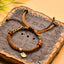 Tibetan Cord Bracelet – brown woven cord with wood beads and gold charm on carved stone, protection jewelry