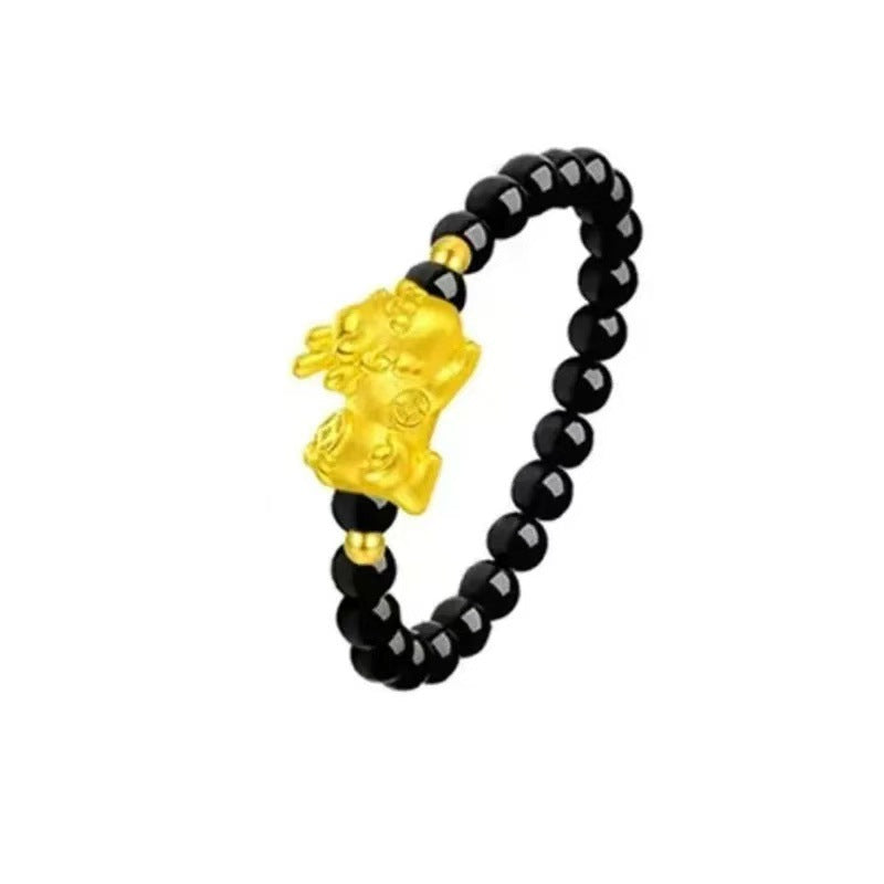 Obsidian Pi Xiu Ring – Black obsidian bead ring with gold Pi Xiu charm on white background, protection jewelry