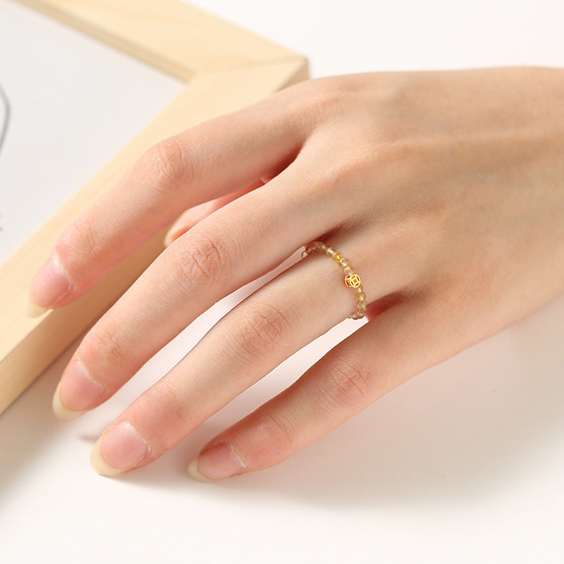 2mm Citrine Ring – Gold tiny bead ring on model hand with gold charm accent, delicate feng shui ring