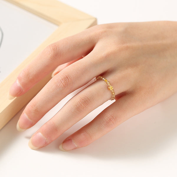 2mm Citrine Ring – Gold tiny bead ring on model hand with gold charm accent, delicate feng shui ring