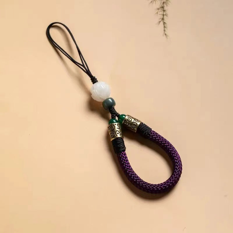 Lotus Bodhi Lanyard – Purple braided cord strap with white carved lotus bead and metal details, wisdom phone accessory