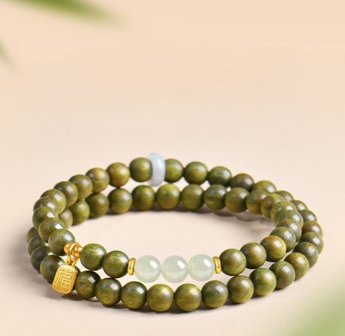 Green Sandalwood Bracelet – Double wrap with white jade and gold fortune charm on beige, natural wood