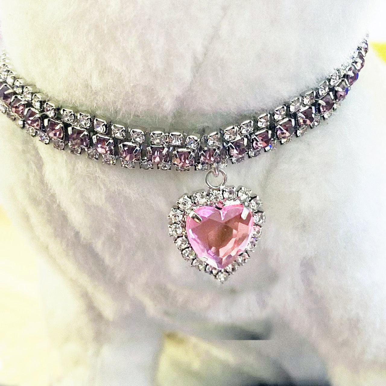 Pink Crystal Pet Collar – Pink rhinestone band with heart pendant on white fur pet, luxury lifestyle dog jewelry