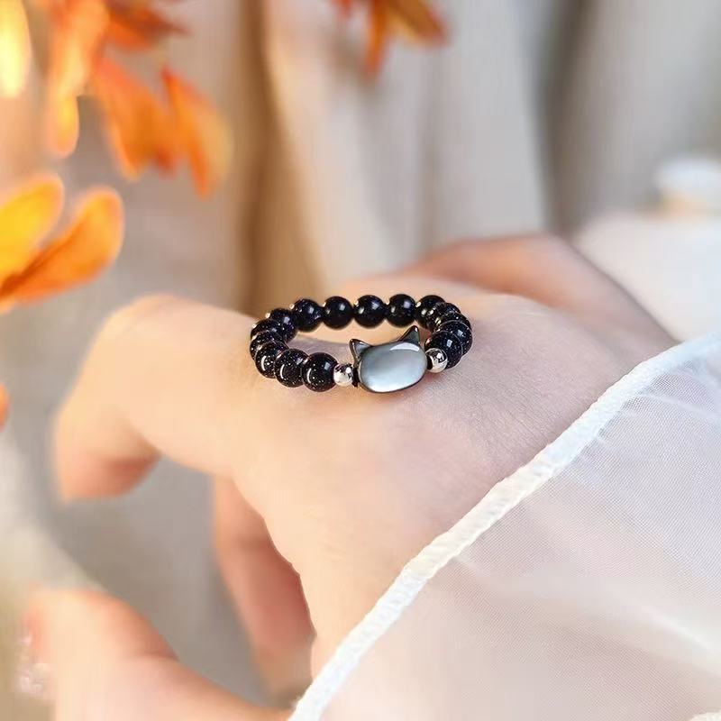 Obsidian Cat Ring – Black obsidian bead ring with silver cat charm worn on finger, cute animal jewelry
