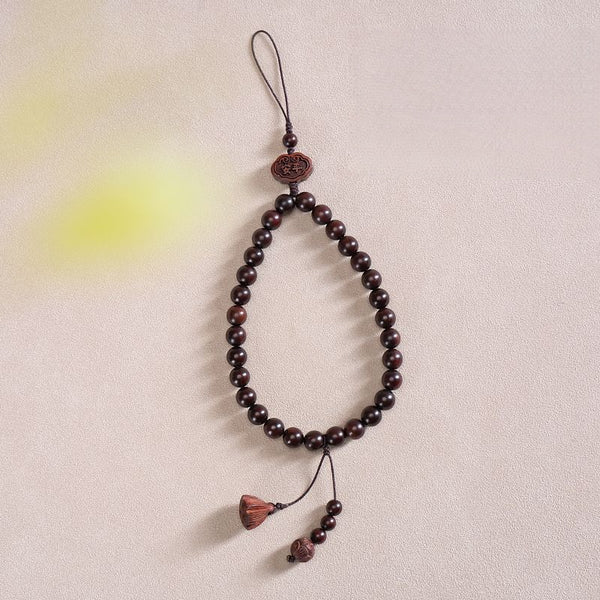 Zodiac Wood Bead Lanyard – Dark red beaded phone strap with lotus and tassel pendant on textured background, elegant zen lanyard