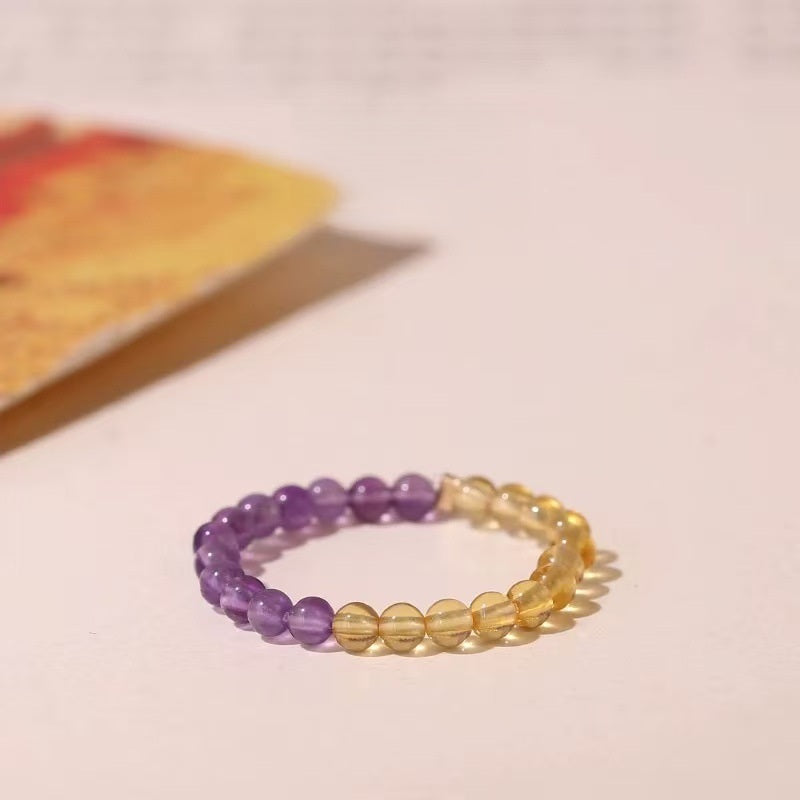 Amethyst Citrine Ring – Purple amethyst and yellow citrine dual-tone bead ring on pink background, chakra ring