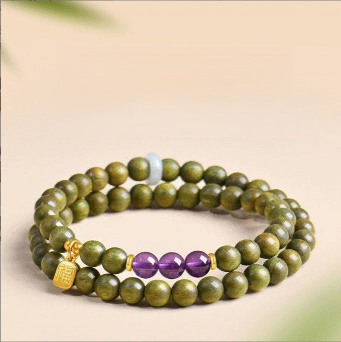 Green Sandalwood Bracelet – Double wrap with amethyst and gold fortune charm on beige, natural wood