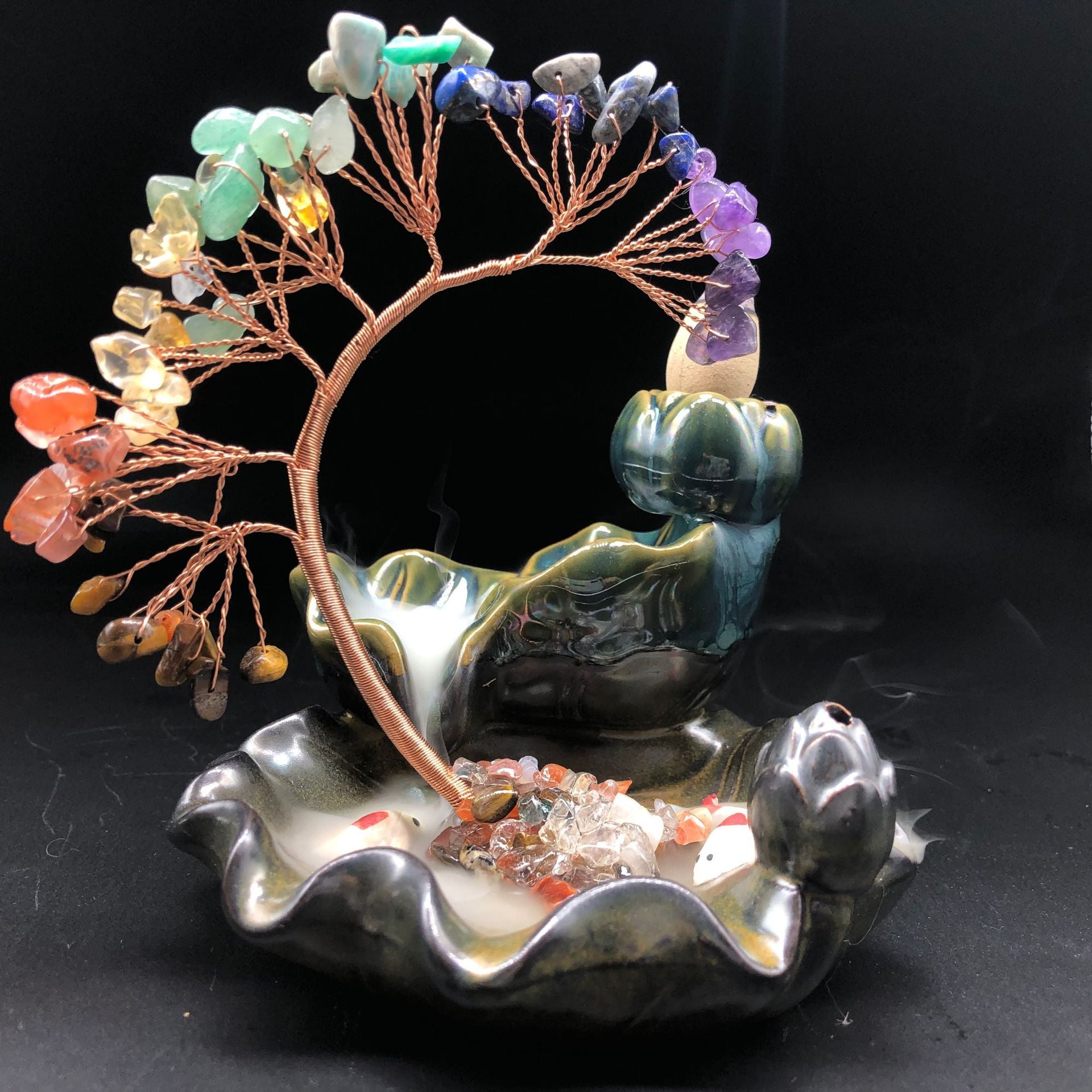 Crystal Tree Incense Burner – copper-wire tree with chakra crystals on lotus base, backflow smoke, black background, Feng Shui decor