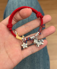 Horse Red String Bracelet – Red cord with silver horse charm and fortune star, hand held over jeans, zodiac