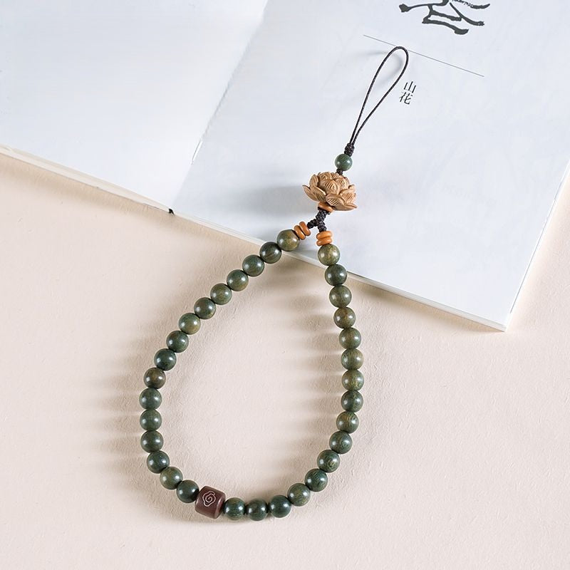 Zodiac Wood Bead Lanyard – Green sandalwood beaded phone strap with carved lotus top on white book, Zen fortune accessory
