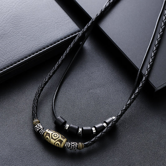 Dzi Bead Necklace – black braided wax rope with gold barrel bead and black hexagon spacers on leather, Tibetan necklace