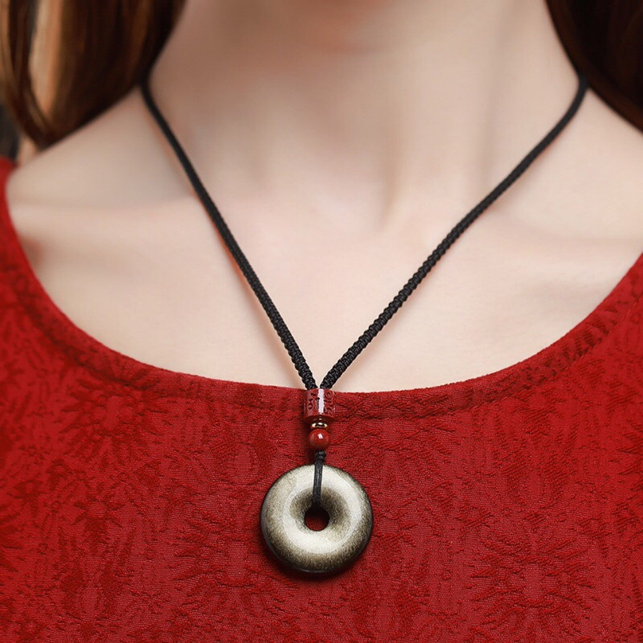 Gold Obsidian Pendant – Gold sheen obsidian necklace worn on black cord with red cinnabar bead, courage amulet
