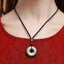 Gold Obsidian Pendant – Gold sheen obsidian necklace worn on black cord with red cinnabar bead, courage amulet