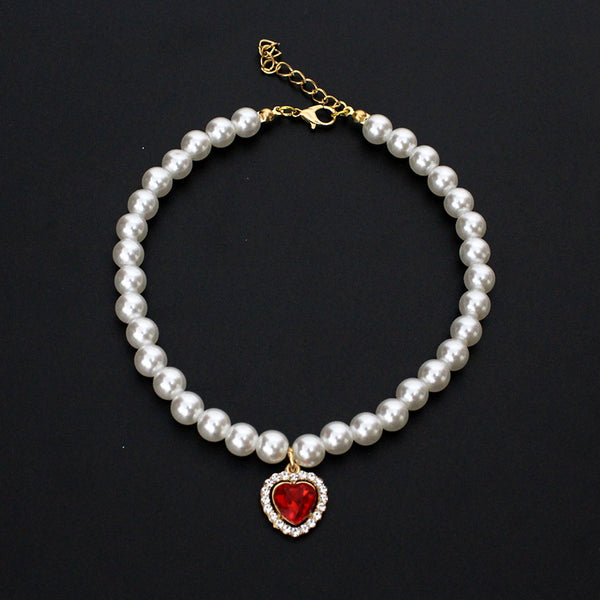 Crystal Heart Pet Necklace – Single strand pearl collar with red heart rhinestone pendant on black background