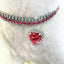 Heart Crystal Pet Collar – silver band ruby red crystals with dangling red heart pendant, fluffy white display