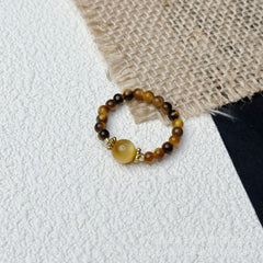 Tiger Eye Beaded Ring – Tiger eye beads with yellow crystal center on burlap and white, wealth ring