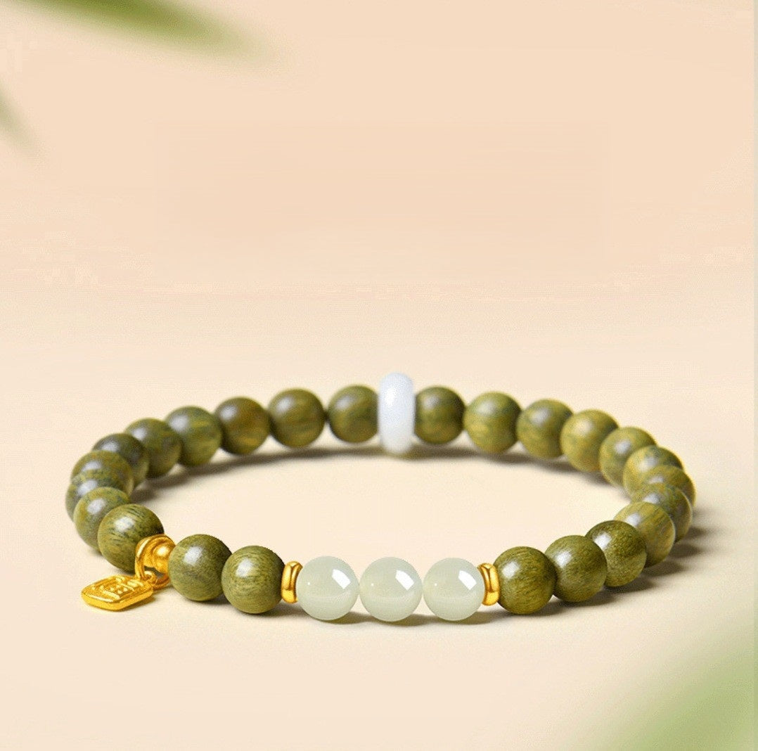 Green Sandalwood Bracelet – Single wrap with white Hetian jade center beads, gold accent on beige background