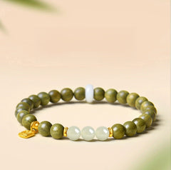 Green Sandalwood Bracelet – Single wrap with white Hetian jade center beads, gold accent on beige background