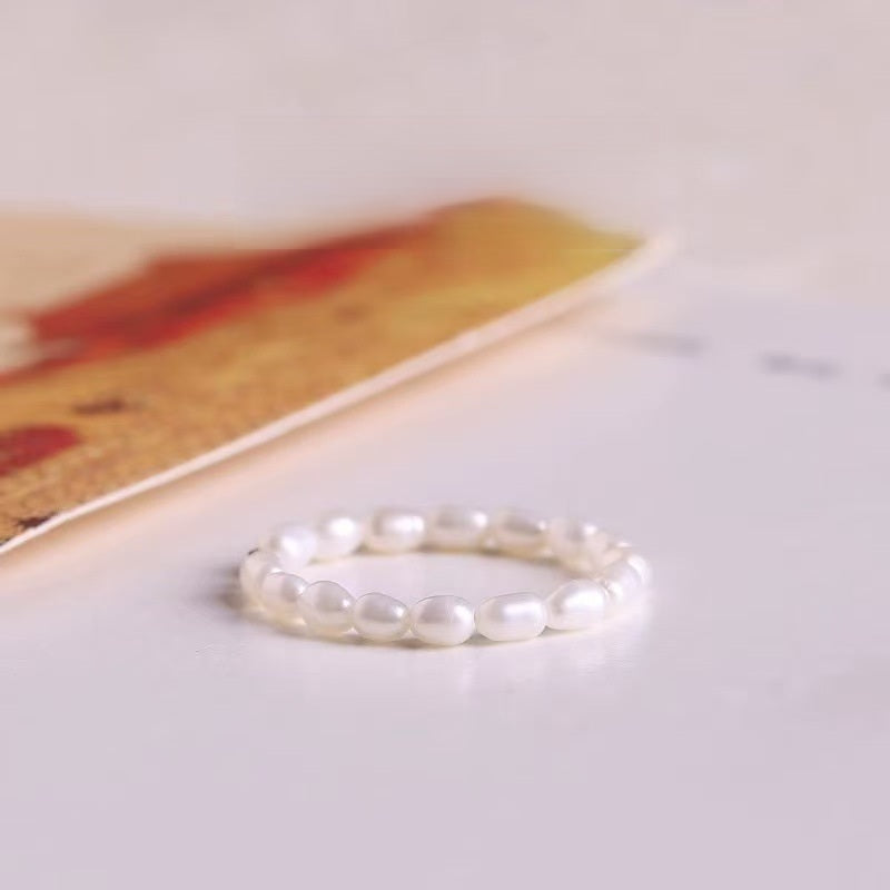 Pearl Ring – White freshwater pearl bead ring on cream surface with art card, elegant minimalist ring