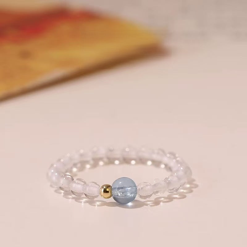 Aquamarine Quartz Ring – Clear quartz bead ring with blue aquamarine center and gold spacers, clarity crystal ring