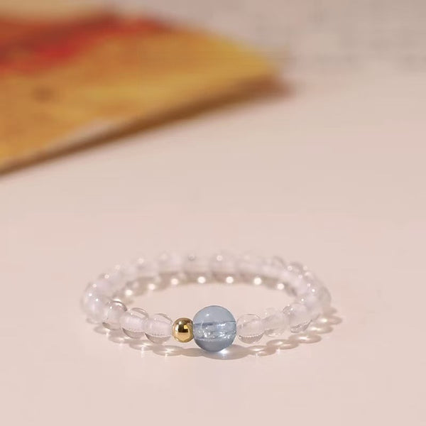 Aquamarine Quartz Ring – Clear quartz bead ring with blue aquamarine center and gold spacers, clarity crystal ring