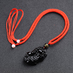 Obsidian Pixiu Necklace – Red braided cord with black obsidian pixiu charm, white bead adjusters on gray
