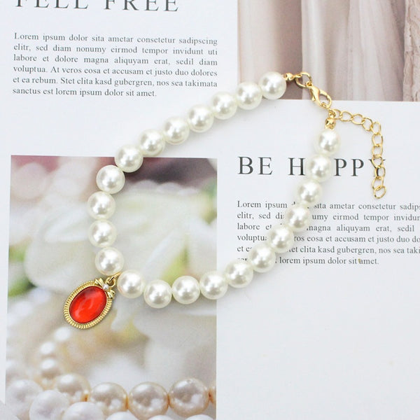 Pearl & Ruby Pet Collar – White pearl strand with red cabochon pendant, gold bezel, vintage luxury pet necklace
