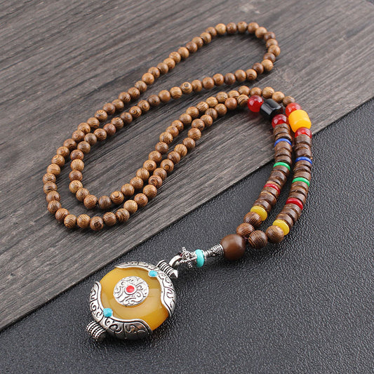 Wenge Mala Necklace – 108 beads with silver-framed yellow pendant and turquoise accents, dark wood surface