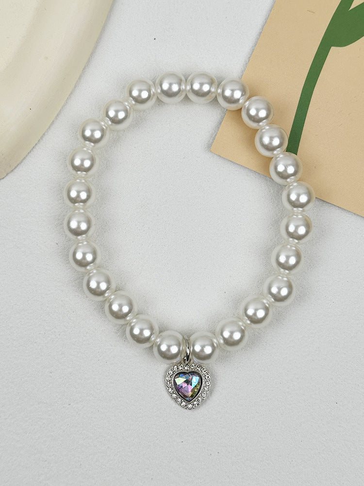 Quartz Heart Pearl Pet Collar – Pearl collar with iridescent AB heart crystal on white fabric, pet accessory