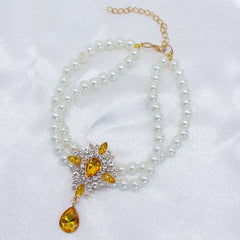 Elegant Pearl Crystal Collar – Double-layer pearl collar with yellow teardrop crystal and rhinestones, satin