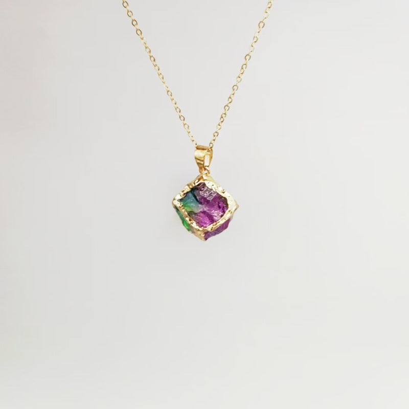 Gemstone Chip Pendant – Purple-green fluorite raw crystal cube in gold frame on chain, white background