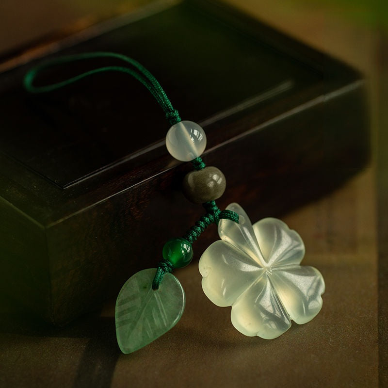 Jade Clover Keychain – white jade four-leaf clover with green leaf charm on dark wooden box