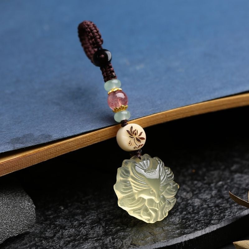 Quartz Fox Keychain – single pale yellow crystal nine-tailed fox pendant on blue book with dark braided cord, spiritual accessory