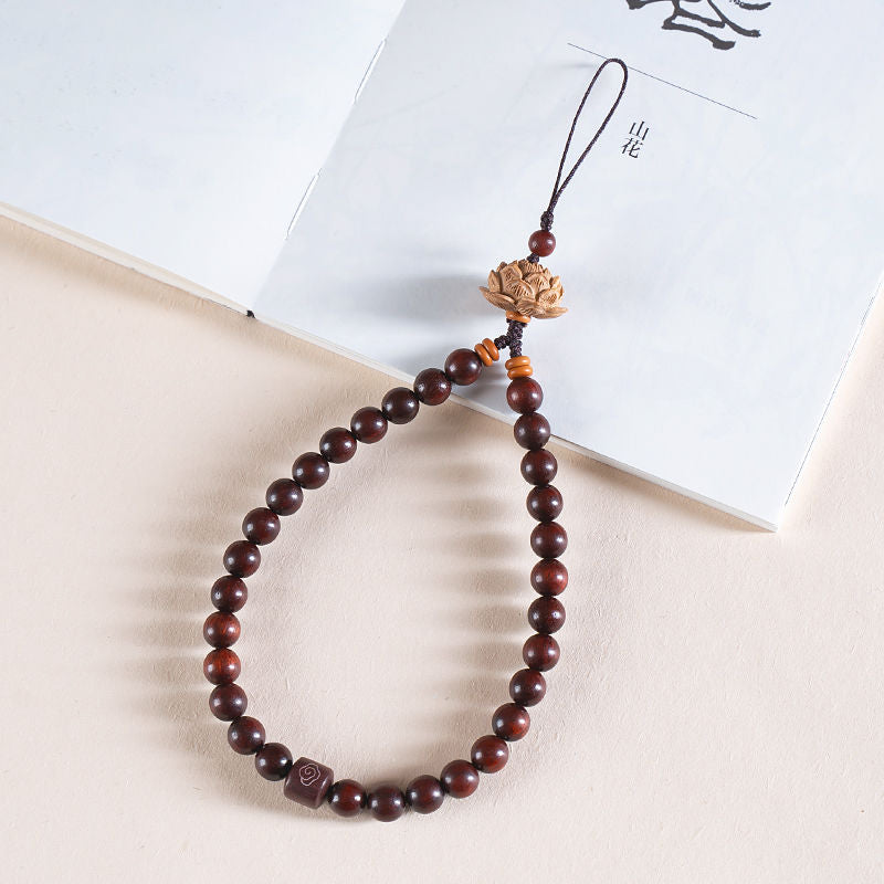 Zodiac Wood Bead Lanyard – Deep red sandalwood bead lanyard with peach wood lotus on open book, auspicious phone charm