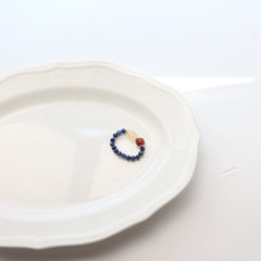 Lapis Lazuli Agate Ring Set – blue faceted lapis beads with square red agate and pale crystal accents, gold details, white plate