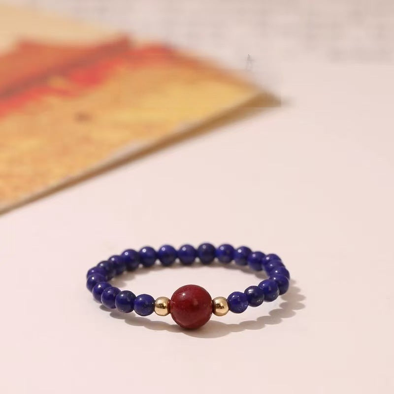 Lapis Cinnabar Ring – Blue lapis lazuli bead ring with red cinnabar center and gold accents, protection ring