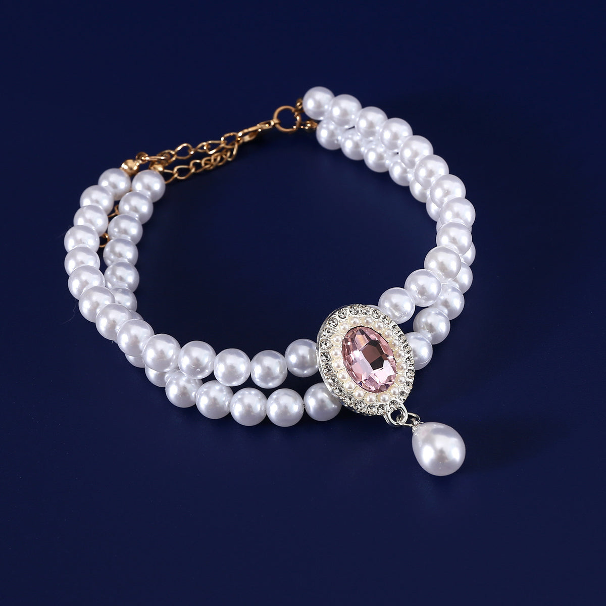 Luxury Pearl Pet Necklace – Double-layer pearl collar with pink crystal center surrounded by rhinestones, navy background